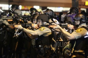 Police officers point their weapons at demonstrators in Ferguson, Missouri, August 18, 2014. (Credit: Reuters/Joshua Lott)