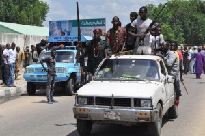 Armed vigilantes and local hunters patrol the streets of Maiduguri, Nigeria on September 4, 2014. Credit: AP Photo / Jossy Ola
