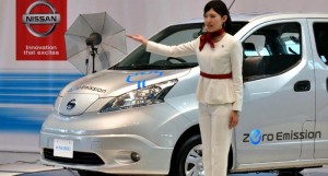 A Nissan employee exhibits an electric vehicle made by the Japanese auto giant  Credit: AFP Photo/Yoshikazu Tsuno