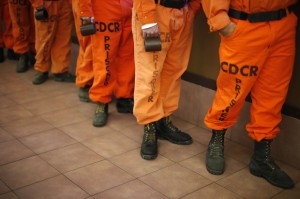 Prison inmates wearing firefighting boots line up for breakfast at Oak Glen Conservation Fire Camp #35 in Yucaipa, California November 6, 2014. Thousands of convicted felons form the backbone of California's wildfire protection force under a unique and little-known prison labor program. But California may soon find it harder to recruit new inmate firefighters after a ballot measure was passed last month to ease prison crowding by reducing felony sentences to misdemeanor jail terms for most non-violent, low-level offenses, including many drug crimes. That measure will likely diminish the very segment of the inmate population that the California Department of Forestry and Fire Protection, or Cal Fire, draws upon to fill its wildland firefighting crews.   Credit: Reuters  /Lucy Nicholson  