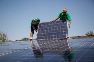 SolarCity Corp. employees install solar panels on the roof of a home in Kendall Park, N.J. Credit: Michael Nagle/Bloomberg