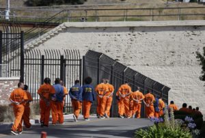 A row of general population inmates walk in a line at San Quentin State Prison. Credit: AP/Eric Risberg