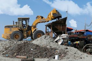 A loader dumps sand into magnetized black sand mining equipment along the shore of San Vicente, Ilocos Sur province, in the northern Philippines.  Credit: Erik De Castro/Reuters