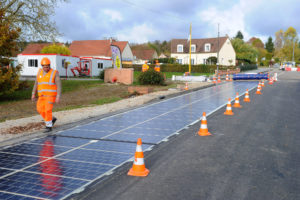 Solar panels, produced by Colas SA's Wattway unit, owned by Bouygues SA, are laid onto a road in this undated handout photo released to the media on Wednesday, Nov. 23, 2016. A subsidiary of Bouygues SA has designed rugged solar panels, capable of withstand the weight of an 18-wheeler truck, that theyÕre now building into road surfaces. Credit: Wattway